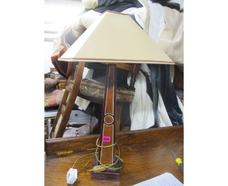 A maroon square lamp with shade 