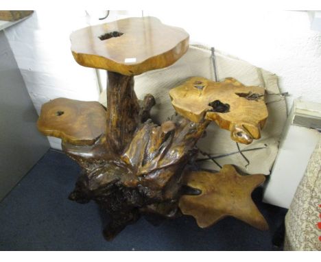 A polished teak root, four tier console table with a central column 