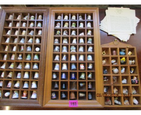 A collection of china, wooden and white metal thimbles to include Worcester, together with three wooden thimble wall display 