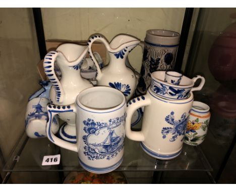 SHELF OF VARIOUS DELFT WARE AND FAIENCE INC. CLOGS, STEINS AND CHAMBER STICK