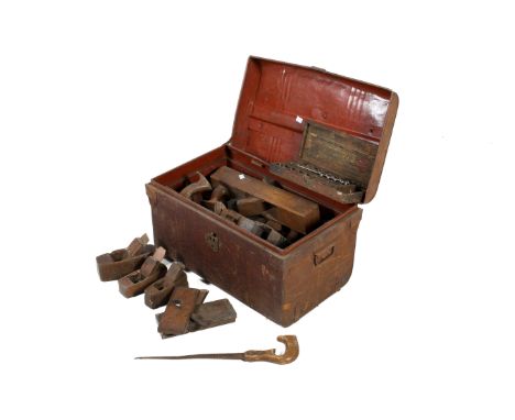 A collection of assorted vintage carpenter's wooden hand tools in a tin chest. Including planes, saws and drill bits, etc. H3