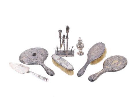 An assortment of silver. Comprising two silver dressing table mirrors with embossed decoration (one AF), two silver backed br