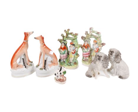 A collection of seven ceramic figures. Including a pair of 19th century greyhounds and a pair of King Charles spaniels, etc. 