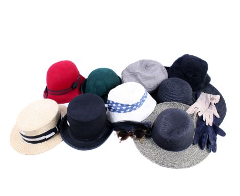 An assortment of vintage and contemporary accessories. Including a pair of sunglasses, a Loevenich hat, a straw hat and more