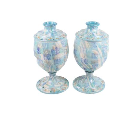 A pair of contemporary ceramic table lamp bases. Of urn form with blue floral glaze decoration raised on a circular base. H45