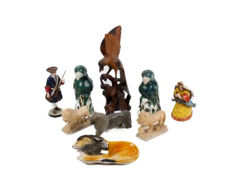 A collection of assorted ornaments mostly animal figures. Including a pair of ceramic parrots and a pair of carved stone lion
