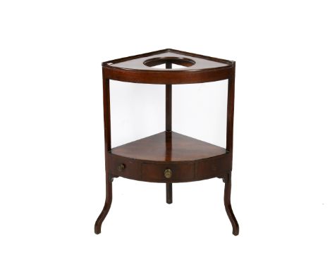 A mahogany corner washstand. Having a shelf beneath with a drawer flanked by two faux drawers. H84cm