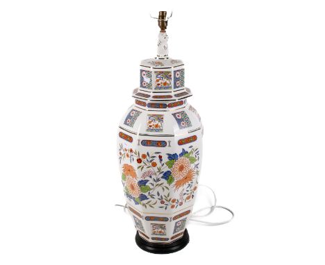 A large contemporary Oriental ceramic ginger jar table lamp. Having a Pekingese dog finial over transfer flower panels raised