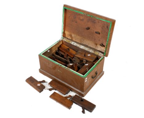 A collection of assorted vintage carpenter's wooden moulding planes in a tool chest. H33cm x W62cm x D42cm