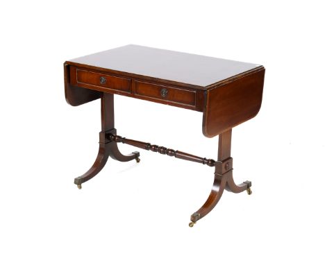 A mahogany regency style sofa table. Having two lower drawers and a turned stretcher raised on brass casters. H74cm x W91cm x