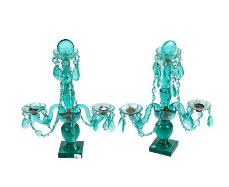A pair of mid-century turquoise glass candelabra. Each having two branches with crystal drops raised on a square plinth. H44c