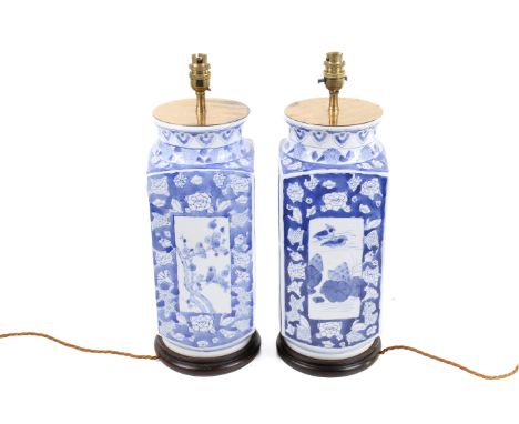 A pair of Chinese blue and white ceramic vase table lamps. Of rectangular form with panels of birds and flowers raised on a t