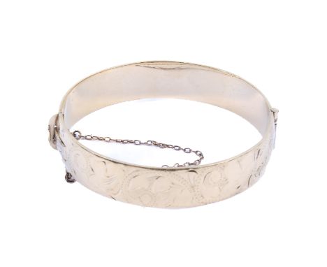 An Excalibur 12ct rolled gold bangle. With engraved floral decoration to one half, width of band 13mm, diameter circa 5.5cm x