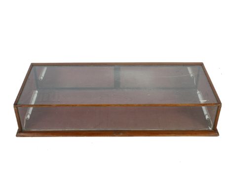 A large vintage tabletop shop display case. Of rectangular form with two drop down doors to the rear. H25cm x W138cm x D57cm