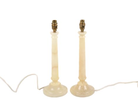 A pair of contemporary Spanish made stone turned table lamps. Of candlestick form on circular plinth bases. H35cm
