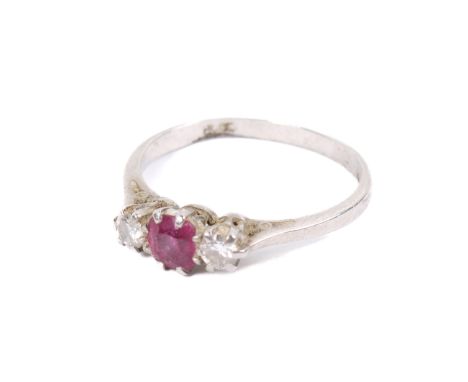 A white metal, ruby and diamond ring. The central pinkish ruby of circa 4mm diameter flanked by diamonds, the shank marked PL