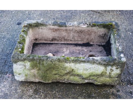 A reconstituted stone garden trough. H29cm x W86cm x D54cm