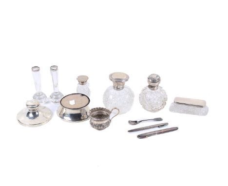 A small group of silver and silver mounted items. Including a small silver Victorian jug, scent bottles, candlestick, silver 
