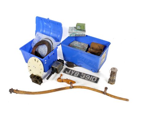 A mixed lot of vintage collectables. Including tins, shoes lasts, a car number plate plus a dismantled wall clock, etc. In tw