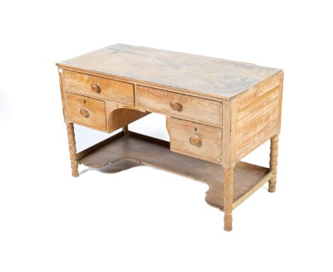 An early 20th century pine desk with simulated bamboo legs. Two long drawers over knee hole flanked by a drawer, a shaped she