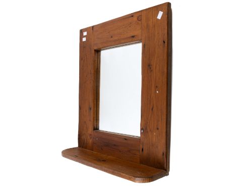 A pine framed wall mirror with integral shelf. 28cm x 37cm