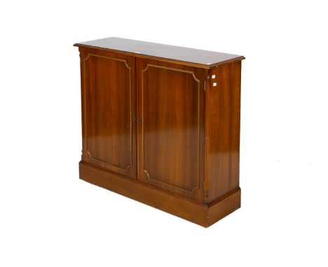 A Georgian style two door walnut cupboard. Doors opening to reveal an adjustable shelf raised on a plinth base with casters. 