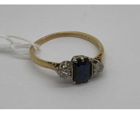A Sapphire and DIamond Three Stone Ring, the centre stone to six claw set, between illusion set brilliant cut diamonds, stamp