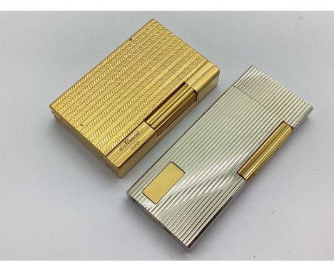 S.T. Dupont Paris Gold Plated Lighter, allover textured finish, numbered "1J9DG89", 5.5cm; together with a slim two tone ligh