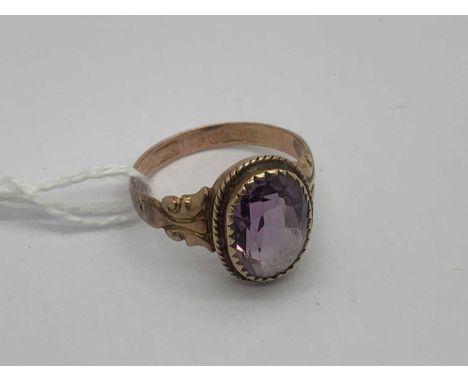 An Antique 9ct Gold Single Stone Ring, the collet set oval stone to decorative scrolling shoulders and tapered band, Chester 
