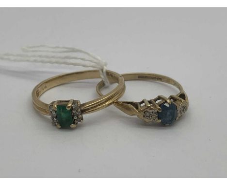 A 9ct Gold Emerald and Diamond Set Ring, the centre stone between line set diamond side stones, to reeded band (finger size Q