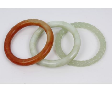 Three old Chinese jade / hardstone bangles CONDITION REPORT Ropetwist bangle weighs approximately 42 grams and measures appro