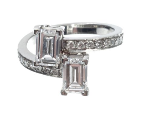 Fine diamond two stone ring with two rectangular step cut diamonds, one weighing 1.02 carats, colour grade E, clarity VVS2, t