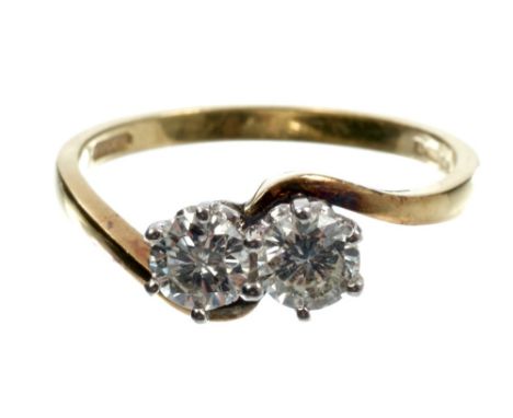 Diamond two stone ring with two brilliant cut diamonds in crossover setting, on gold (18ct) shank.  Estimated total diamond w