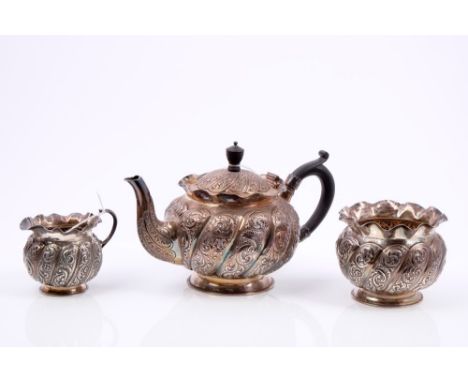 Victorian silver three piece bachelor tea set, comprising teapot of bullet form, with embossed wrythen scroll and foliate dec