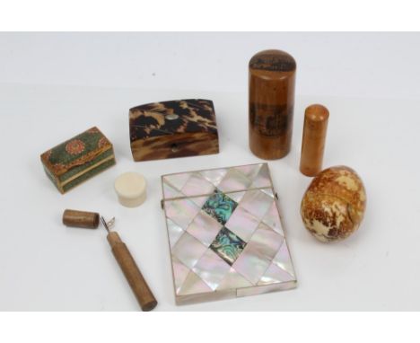 Carved ivory egg, the base unscrewing on a thread, together with a Victorian mother of pearl card case, 19th century tortoise