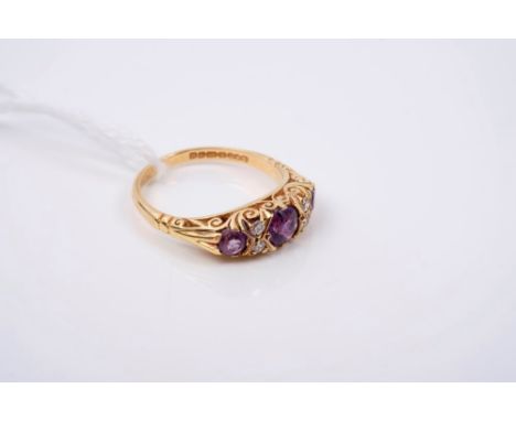 Victorian-style amethyst and diamond ring with three round mixed cut amethysts and four single cut diamonds in carved gold se