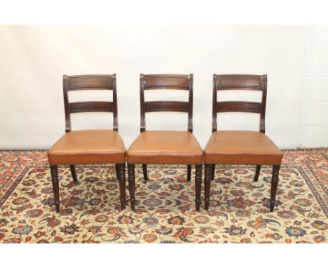 Set of six late Regency mahogany dining chairs, each with tablet bar back and button closed leather upholstered seats, on tur