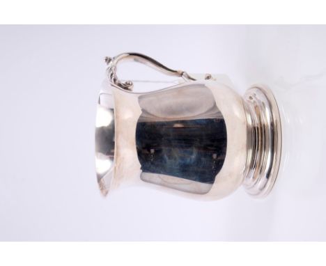 Contemporary silver mug of baluster form, with scroll handle, on circular stepped and domed foot (Birmingham 1977), maker - R