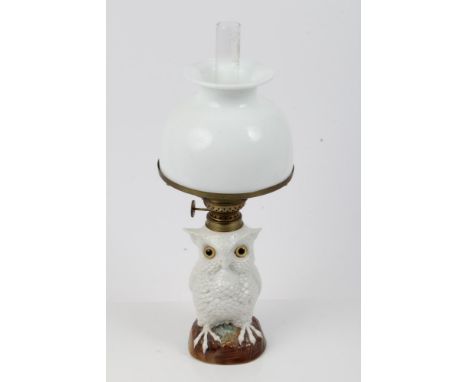 Late 19th century German porcelain oil lamp in the form of an owl with glass eyes, with brass fitting and opaque glass shade 