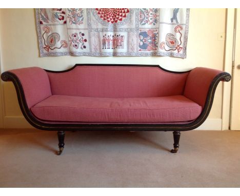 19th century French Empire ebonised sofa upholstered in red and cream material, with gilt painted borders, shaped back and sc