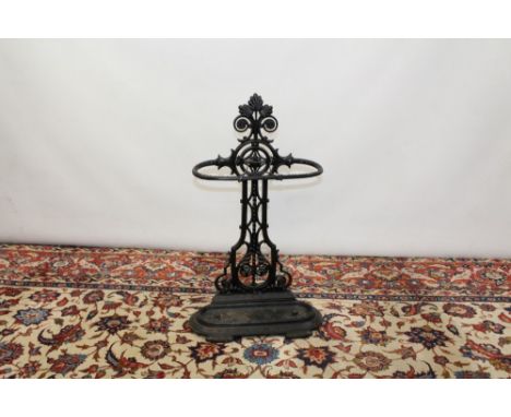Victorian black painted cast iron stick stand in the Aesthetic style, with geometric pierced leaf ornamented column and remov
