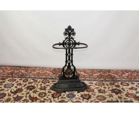 Victorian black painted cast iron stick stand in the Aesthetic style, with geometric pierced leaf ornamented column and remov