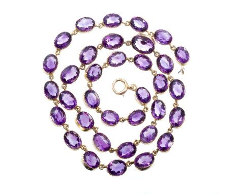 Late Victorian amethyst necklace with thirty-five graduated oval mixed cut amethysts in gold collet setting, 43cm long CONDIT