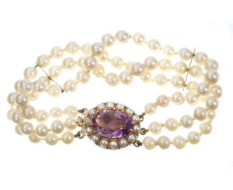 Cultured pearl bracelet with a triple strand of cultured pearls on a large amethyst and cultured pearl oval clasp