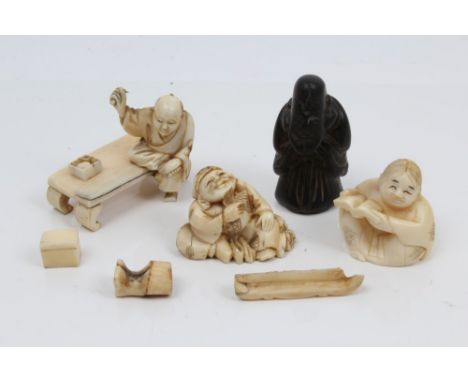 Two late 19th century Japanese carved ivory netsukes of seated man and girl, wooden netsuke, ivory okimono of a scholar and o