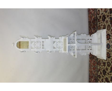 Victorian white painted cast iron hall stand in the Aesthetic style, of high back form, with arched mirror and pierced and fl