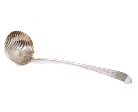 George III Irish silver soup ladle with shell bowl and bright cut decoration and engraved armorial crest and initial (Dublin 