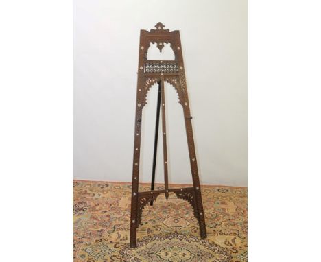 Moorish carved hardwood and mother of pearl inlaid easel, relief carved with scrolling arabesque, 171cm high CONDITION REPORT