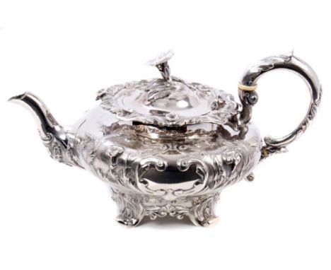 William IV silver teapot of compressed baluster form, with embossed floral decoration, engraved armorial crest and initial, f