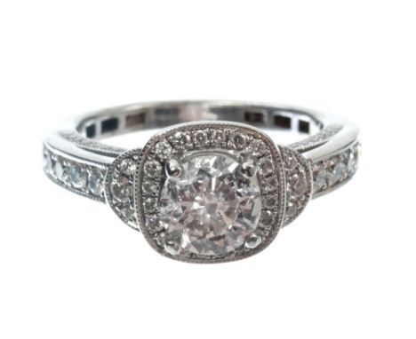 Diamond single stone ring with a brilliant cut diamond estimated to weigh approximately 1 carat, in claw setting surrounded b